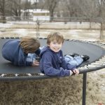 Two Boys Playing on Trampoline