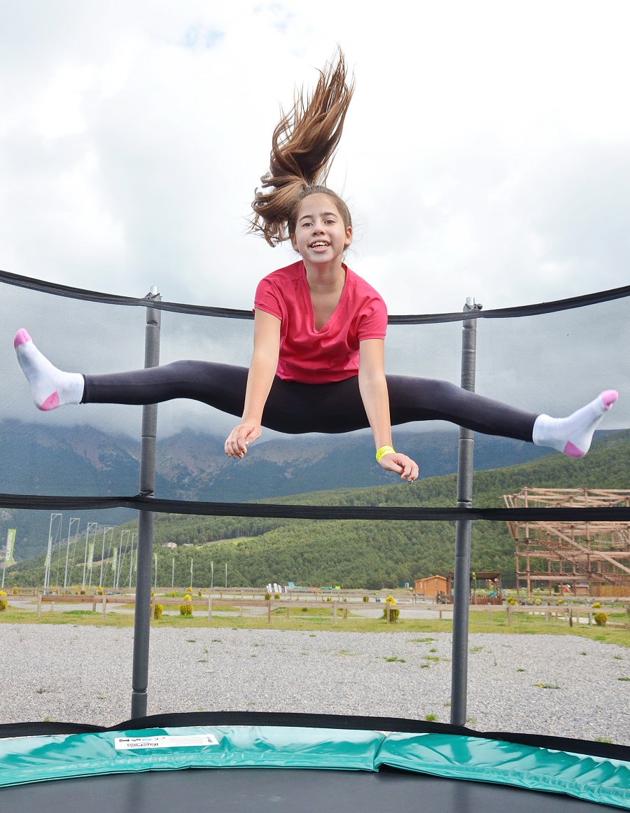 Teenage girl jumping on a trampoline.
